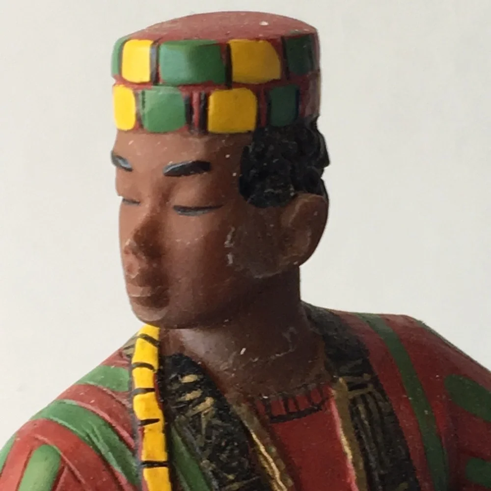 Man in African Tribal Wear Playing Drum Figurine